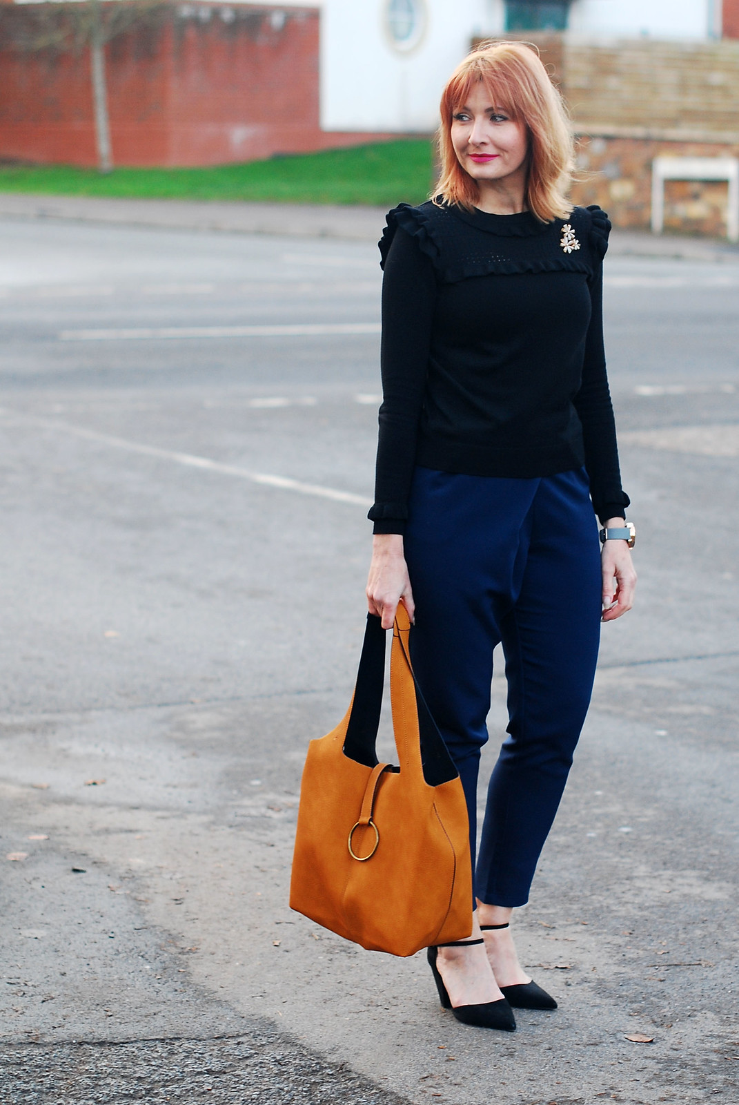 Navy and black together: Navy peg leg trousers black ruffled sweater black pointed heels mustard bucket bag | Not Dressed As Lamb, over 40 style
