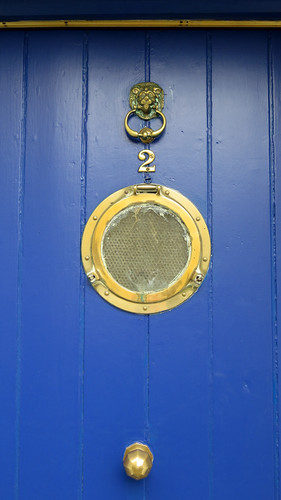 A Bright Blue Door with a Porthole Window in Kinsale, Ireland