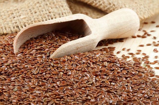 linseed, flax seeds, wooden scoop, hessian bag