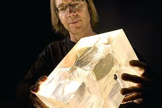 The author holds a cracked sample of acrylic used to study damage effects linked to faulting. Johnson hopes Laboratory research can lead to better forecasting of earthquakes someday. (Photo: LANL)