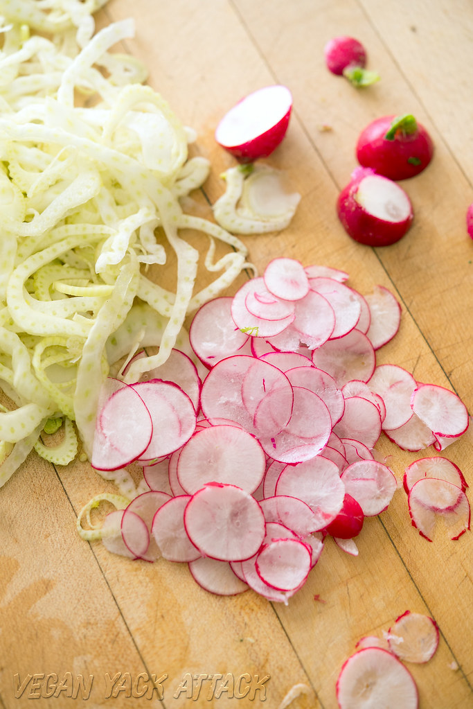 Image of thinly sliced radish and fennel on a cutting board