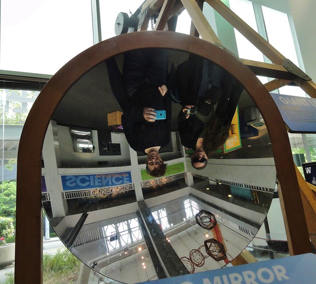 Image shows a parabolic mirror, with Aoife and I reflected upside-down in it.