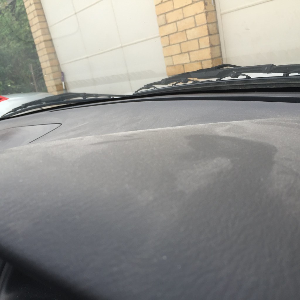 a not-so-thin layer of dust on the dashboard of the car
