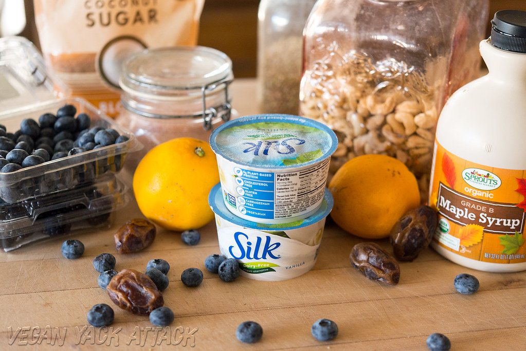 Ingredients for recipe, including vegan yogurt, dates, lemon, blueberries, and cashews
