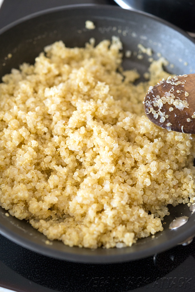 Image of fluffy, cooked quinoa in a pan on the stove.