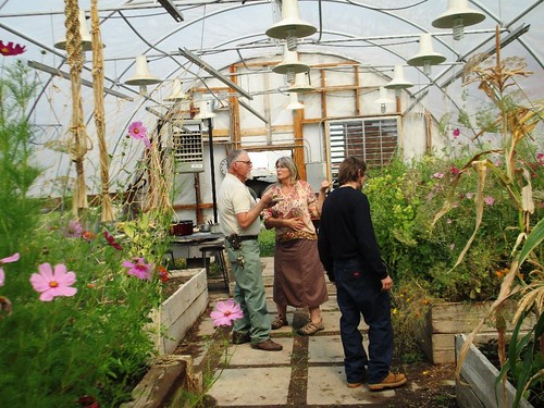 Boxelder instructors Jerry Hood and Rae Rowell, along with student Seth Brand-Tindale admiring the flowers and vegetables in the Center’s greenhouse