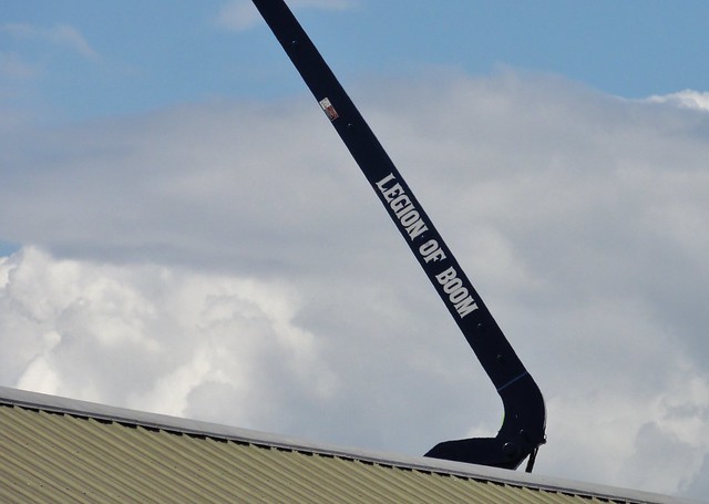 Image shows the black boom of a construction crane. 