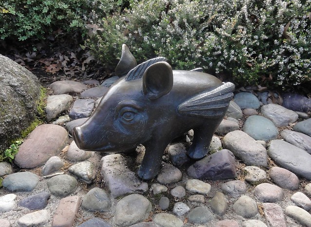 Image shows a small bronze pig with wings.