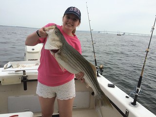 Photo of girl holding striped bass