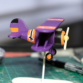 Painting a wooden toy aeroplane