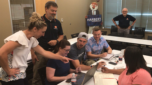 Five Auburn students work with two business faculty members.