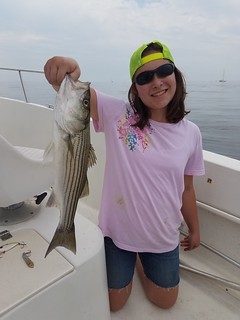Photo of Girl holding striped bass