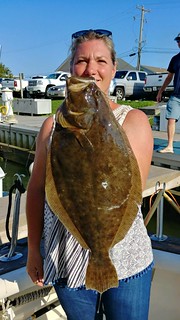 Photo of Woman holding a large flounder