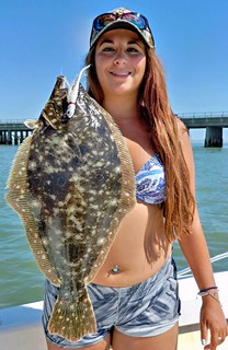 Photo of woman holding a flounder
