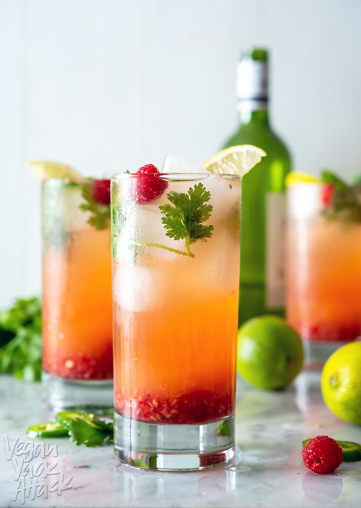 This Pineapple Raspberry Wine Spritzer is perfect for keep you cool during these hot summer months! Sweet pineapple, tart raspberry, plus fresh herbs, white wine, and sparkling water; does it get any better? #vegan #spritzer #beverage