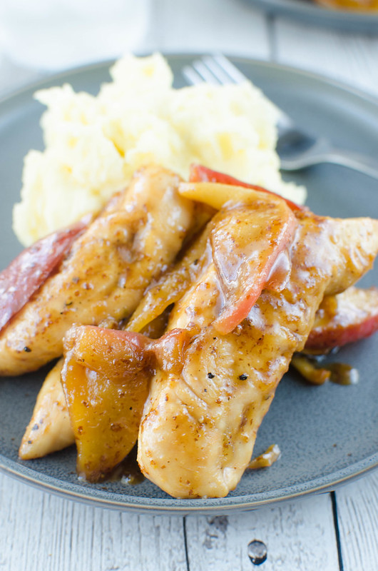 Apple Mustard Chicken Tenders - family favorite fall recipe! Chicken tenders topped with sweet and spicy sauteed apples. Ready in 20 minutes and perfect over mashed potatoes or rice to soak up all the sauce!