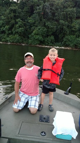 Boy and his grandfather on a boat.