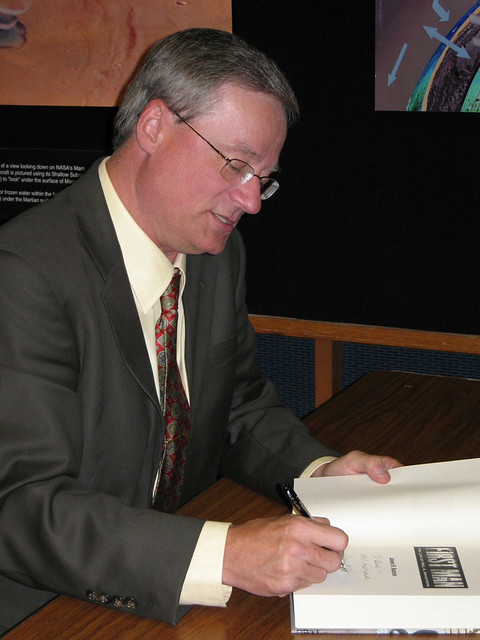 Jim Hansen signs a book. 