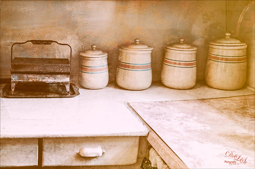 Image of a vintage waffle iron and kitchen cannisters