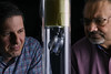 Cristian Pantea with a blue and red checkered shirtand Dipen Sinha with a red checkered shirt with the Acoustic Collimated Beam (ACCObeam), both looking at a tube