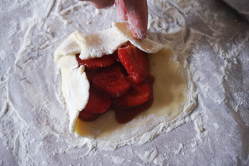 Mini gluten free strawberry rustic pies: adding the filling and folding the sides over