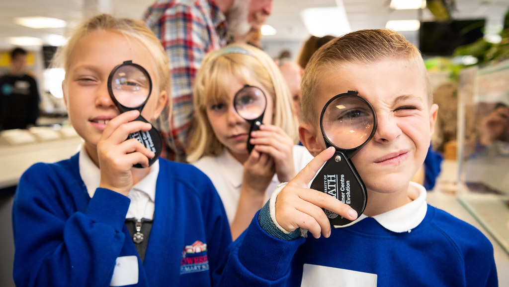 Children looking through magnifying glasses