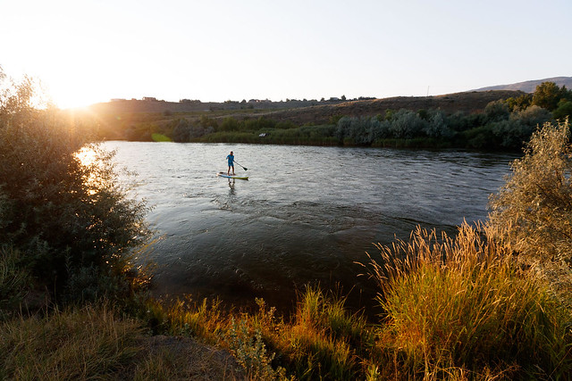 A paddleboarder enjoys an afternoon on the North Platte River adjacent to the Rim Rock property. Photo courtesy of The Conservation Fund. 