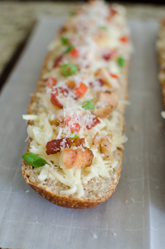 Chicken Alfredo French Bread Pizza - easy weeknight meal the whole family will love! French bread layered with alfredo sauce, chicken, bacon, green onions, tomatoes, and 2 cheeses. 