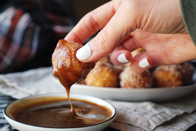 Gluten free churro donut holes rolled in cinnamon sugar and dipped in a homemade caramel sauce.