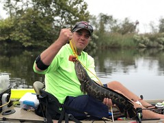 Photo of Man with snakehead in kayak