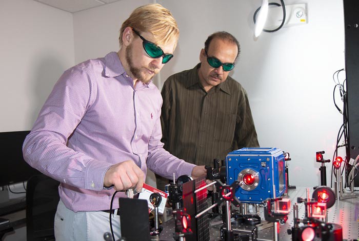 Los Alamos scientists Alexander Malyzhenkov and Alonso Castro demonstrate levitating uranium particles with laser beams.