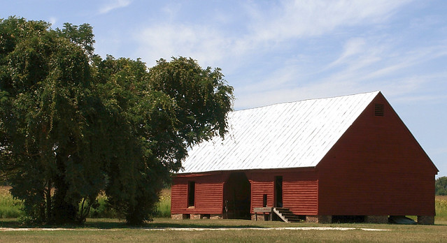 A red hay barn sits quietly in a field at Belle Isle State Park, Virginia
