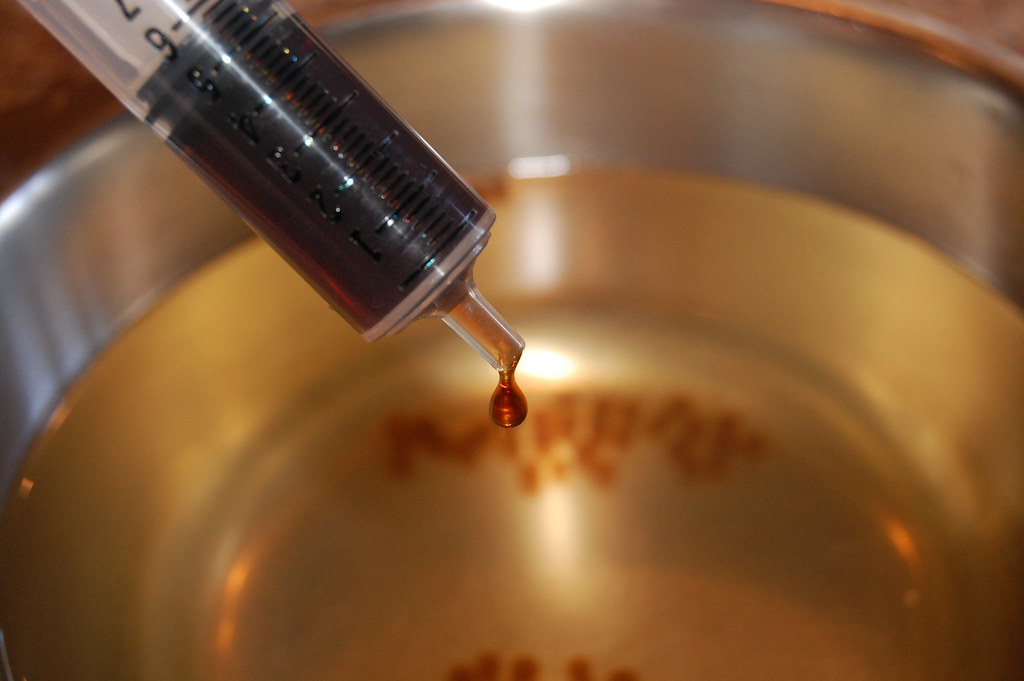 coffee liquid dripping from syringe