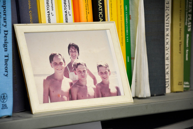 Photo of Lindner's wife and three sons at the beach sitting on his office bookshelf