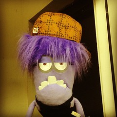 A 'Scumbag Steve' hat on a skinny purple Muppet.
