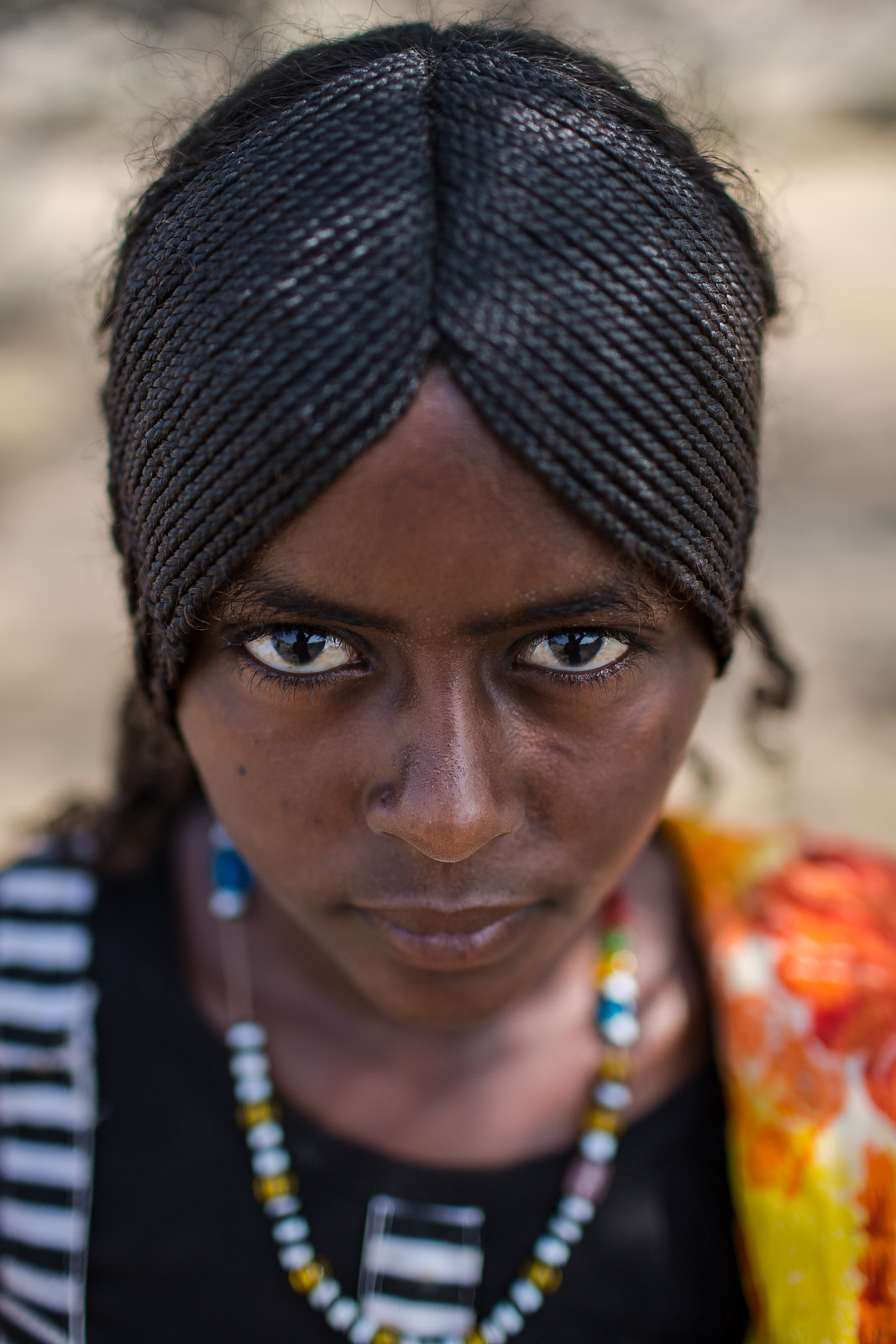 Portrait of an Afar tribe girl with braided hair and 
