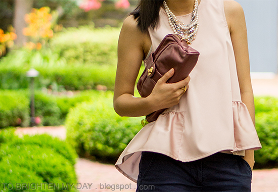 pearl and mixed metal necklace, pink peplum top, navy shorts, rose pink clutch