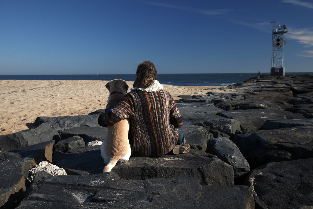 Photo of a dog and master at beach by Ink Byers