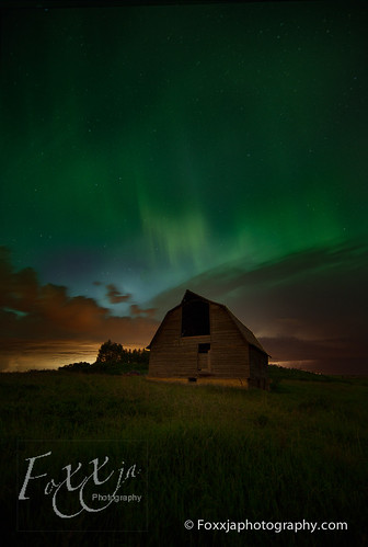 Barn with aurora and storm coming from the North