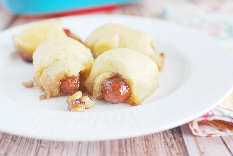Sweet Lil Smokies - lil smokies wrapped in crescent rolls and baked in a honey pecan sauce. These are always the first thing gone from my parties! 