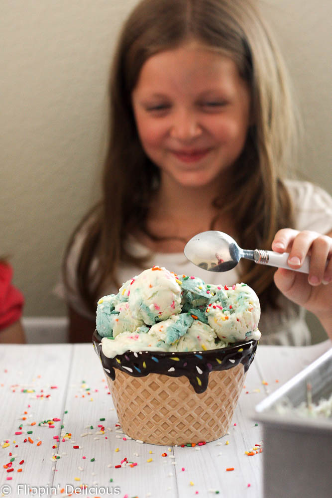 Creamy No-Churn Gluten-Free Birthday Cake Batter Funfetti Ice Cream, complete with a sweet buttercream frosting swirl and a healthy serving of sprinkles. Just like your favorite creamery cake batter ice cream, but better because it is gluten-free!