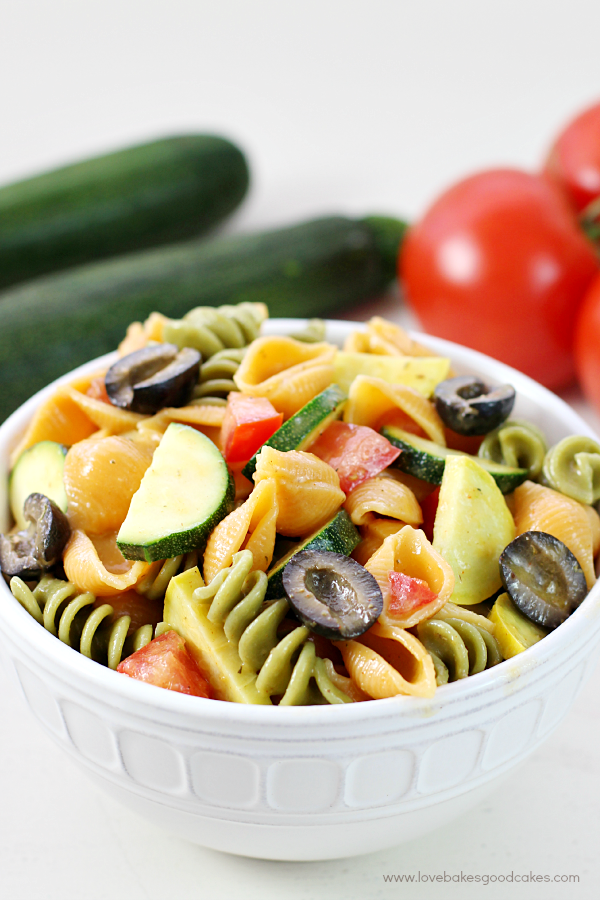 Summer Veggie Pasta Salad in a bowl with fresh vegetables.