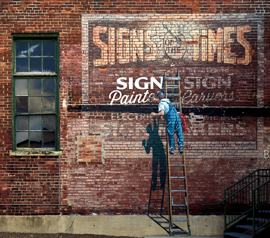 Signs of the Times -- An elaborate painted sign, of four completed in three days in 2015 by "lettermen," as artistic sign painters call themselves, who met for a convention in Cincinnati, Ohio, and stopped by the American Sign Museum in the industrial Camp Washington neighborhood to see the museum and demonstrate their trade. 