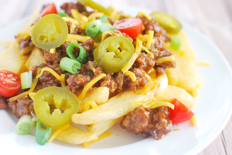 Sloppy Joe Fries - fries topped with sloppy joe meat, melted cheese, green onions, grape tomatoes, and jalapenos! Perfect football food!