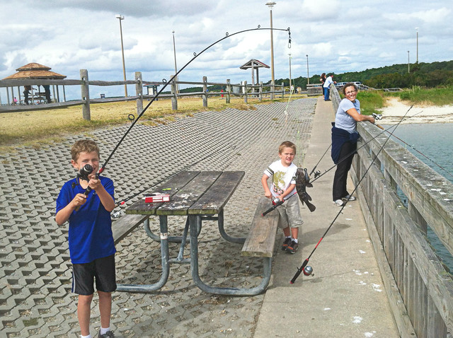 Family fishing together on the pier at Kiptopeke State Park, Virginia