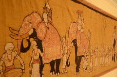 An Indian-looking tapestry featuring a parade of elephants.