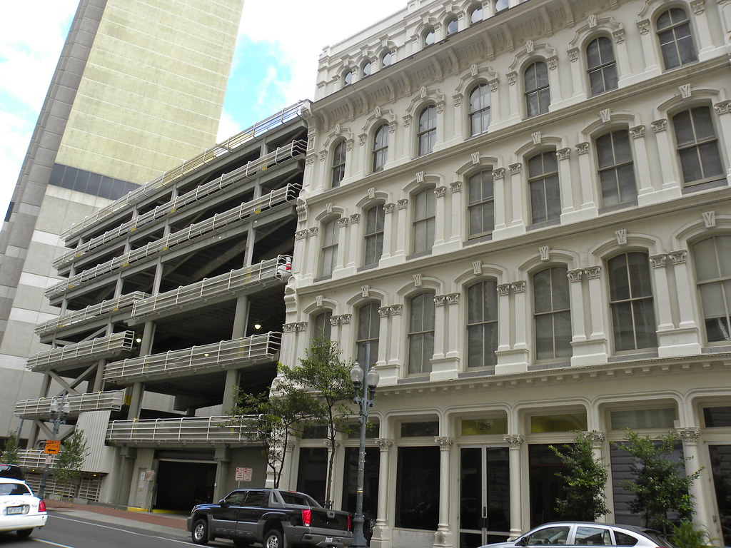 The St. Christopher Hotel's facade beside a parking garage as seen from the street.