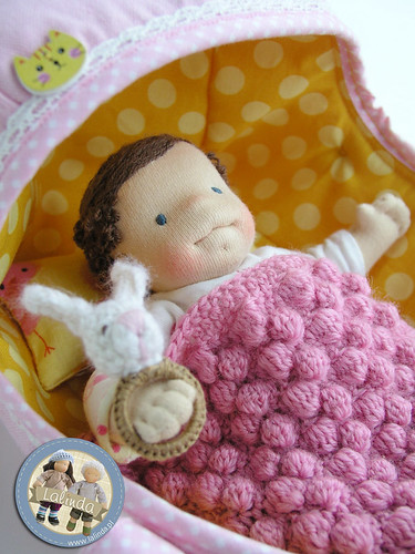 Tiny baby doll with a carrier