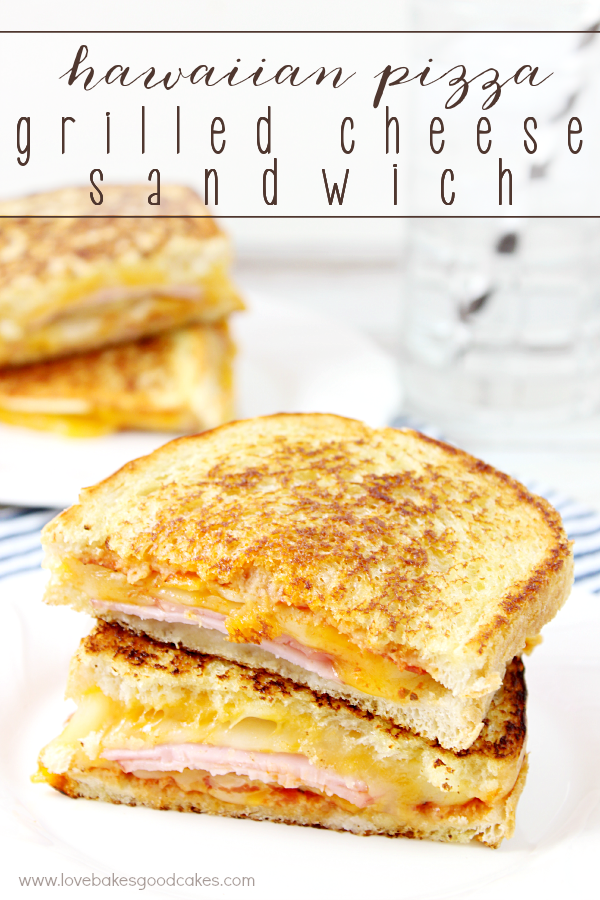 Hawaiian Pizza Grilled Cheese Sandwich sliced in half on a plate.
