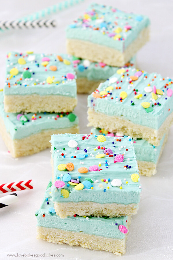 Sugar Cookie Bars stacked on parchment paper.